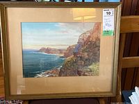Full image of the framed and matted watercolour painting showing the coastal landscape and frame.