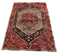 Full view flat on floor showing overall pattern, geometric medallion and border