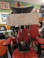 Photo of the retro table lamp showing the fabric shade and sculptural base with decorative bulbs and elements.