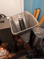 Photo showing large industrial-style metal conical horn loud speaker with black cylindrical mount in center.