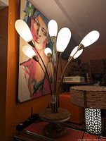 Seven-arm lamp viewed from front showing frosted glass shades and brass-tone arms