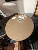 Top down view of the vintage round scale showing surface and triangular dial window