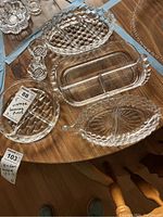 Photo showing all five vintage crystal and cut glass serving pieces on a wooden table.