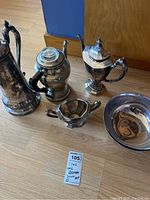 All five pieces arranged on floor, overview of lot contents