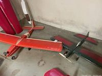 Photo of two model airplanes on the floor, one orange and one green, showing general condition and size.