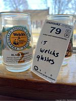 Close-up of Welch's glass labeled Black Rhino with WWF logo and MaxSold tag showing 15 glasses in total