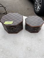 Two brown checkered octagonal trinket boxes with metal clasps on the front.
