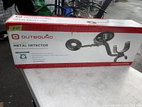 Full view of the Outbound metal detector in its original packaging box showing the product image and branding.