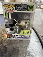 Beetlejuice Funko Pop! Movies vinyl figure in original window box with visible wear on the packaging