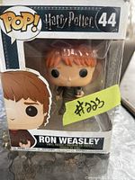 Photo showing the Ron Weasley Pop! Movies vinyl figure in its original box, with visible age wear on the packaging.