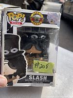 Photo showing the Funko Pop! Rocks Slash vinyl figure in original box with some wear and sale sticker