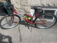 Full side view of the red Supercycle SC 1800 bicycle showing frame, tires, and saddle.