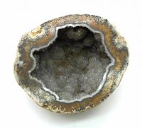 Top view of the geode showing crystalline interior and banded mineral layers.