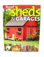 Front cover of Sunset Sheds & Garages instructional book showing clear image of red shed with window boxes and detailed building plans tagline.