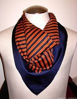 Scarf worn on a display form, showing striped pattern and navy border