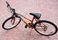 Full side angled view of the vintage Supercycle 18 speed bicycle showing frame, tires, pedals, crank, saddle, handlebars, reflectors, and stand.