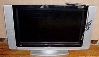 Front view of the 38-inch Acer TV showing the black screen surrounded by silver speaker panels on each side and a middle base stand.