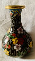 Front side of vintage cloisonné vase showing detailed floral enamel decoration on black background with gold-accented rim.