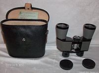 Vintage Limar binoculars with lens caps and black carrying case with strap open showing interior label