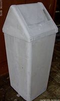 Front and side view of the white plastic trash can with swing top lid
