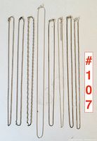 Overview of eight sterling silver chains laid flat side by side