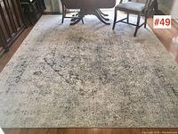Full view of rug under dining table and chairs on hardwood floor