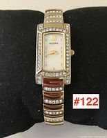 Front view of watch on display pillow showing full watch and diamond accents