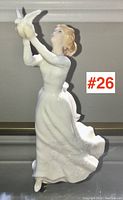 Frontal view of the Royal Doulton figurine showing the woman holding two birds