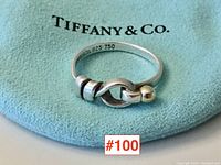 Ring on Tiffany & Co. pouch showing profile view and interior hallmark 'TIFFANY&Co 925 750'