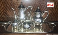 Full view of the 4-piece silver-plated tea/coffee service set displayed on the tray showing all items together.