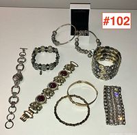Overview of all eight vintage costume bracelets laid out on a surface.