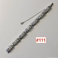 Full view of the vintage sterling silver and marcasite bracelet laid flat with visible safety chain clasp.