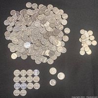 Top photo showing a large number of Canadian 5 cent coins in varying conditions grouped together, with some quarters and dimes separately placed on black background.