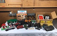 Overall lot on table showing buildings, trains, track, controllers and accessories