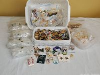 Large assortments of pins sorted into bins and bags showing the expansive lot.