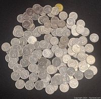Image showing a large pile of Canadian quarters with visible RCMP mounted police on many coins.