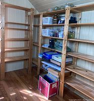Left narrow 4-shelf unit and center wide 3-shelf unit with storage items