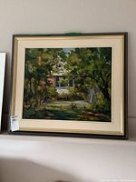 Overall view of framed oil painting depicting a house among trees