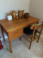 Desk and chair full view showing desk top and attached drawers with chair next to it