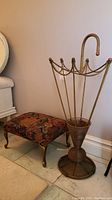 Side view showing the floral upholstered stool and the umbrella-shaped iron stand with copper finish.