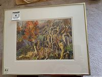 Framed watercolour painting showing the full artwork with a white mat and light frame. Autumn foliage and dried plants depicted.
