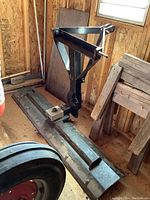 Full assembly of blade and mounting bracket inside shed