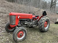 Side view of red Massey-Ferguson 50 tractor outdoors
