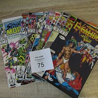 Photo showing all 10 comics fanned out, including Strikeforce Morituri #2, #4 and multiple Excalibur issues, with colorful Marvel comic book covers visible.