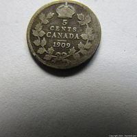 Reverse side of 1909 Canadian silver 5 cents coin showing denomination and date within maple leaf wreath topped by a crown.