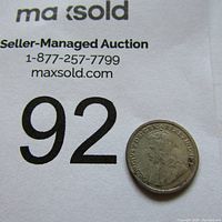 Photo of the 1912 Canadian silver 5 cents coin with King George V portrait, showing worn condition.