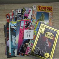 Top-down photo showing a stack of colorful comic books with visible titles Turok Dinosaur Hunter, Zen, and Robo the Machineman.