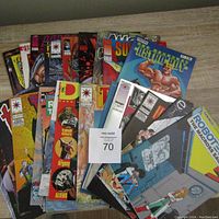 Photo of stacked comic books showing colorful and varied covers including Turok and Astro Boy titles.