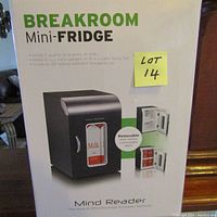 Photo showing front of unopened Breakroom Mini Fridge box with product features and brand name visible.