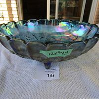 Side view showing the scalloped edge and iridescent blue finish of the carnival glass dish with measurement sticker 12x9x4